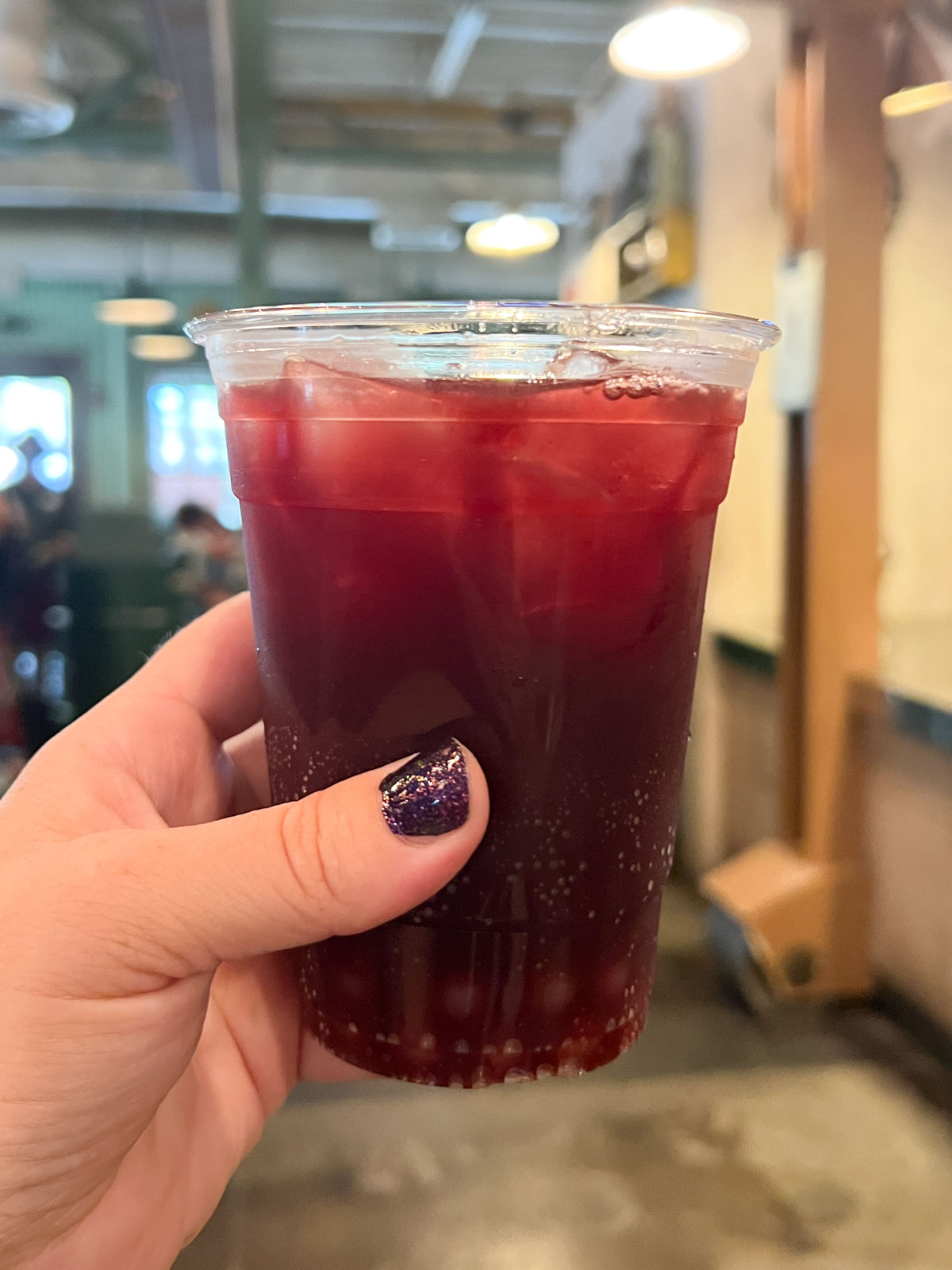 hand holding a cranberry punch in a cup