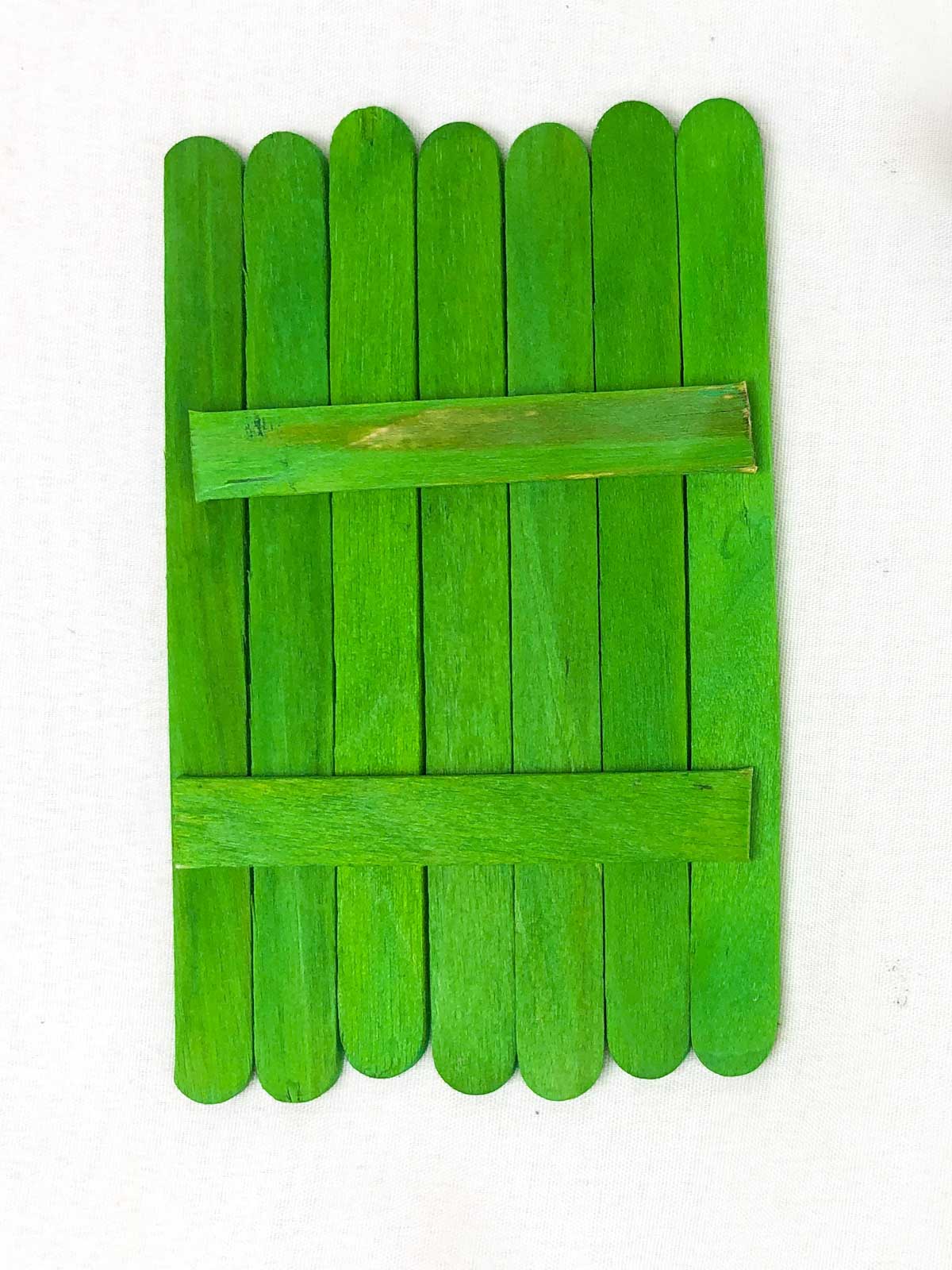 green popsicle sticks glued together