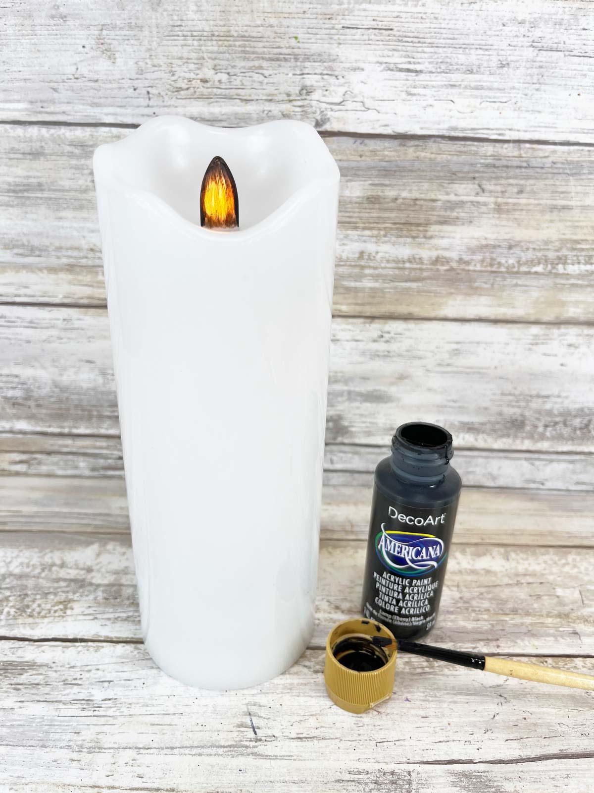 white candle with black paint
