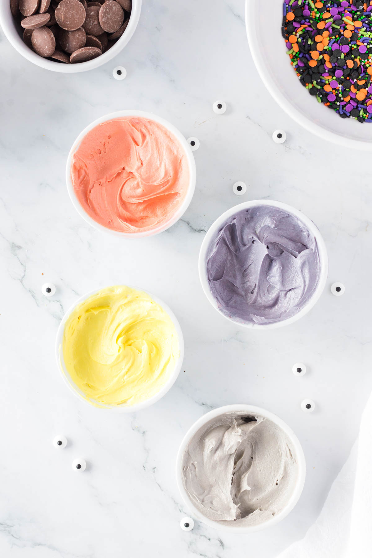 colored buttercream in small bowls