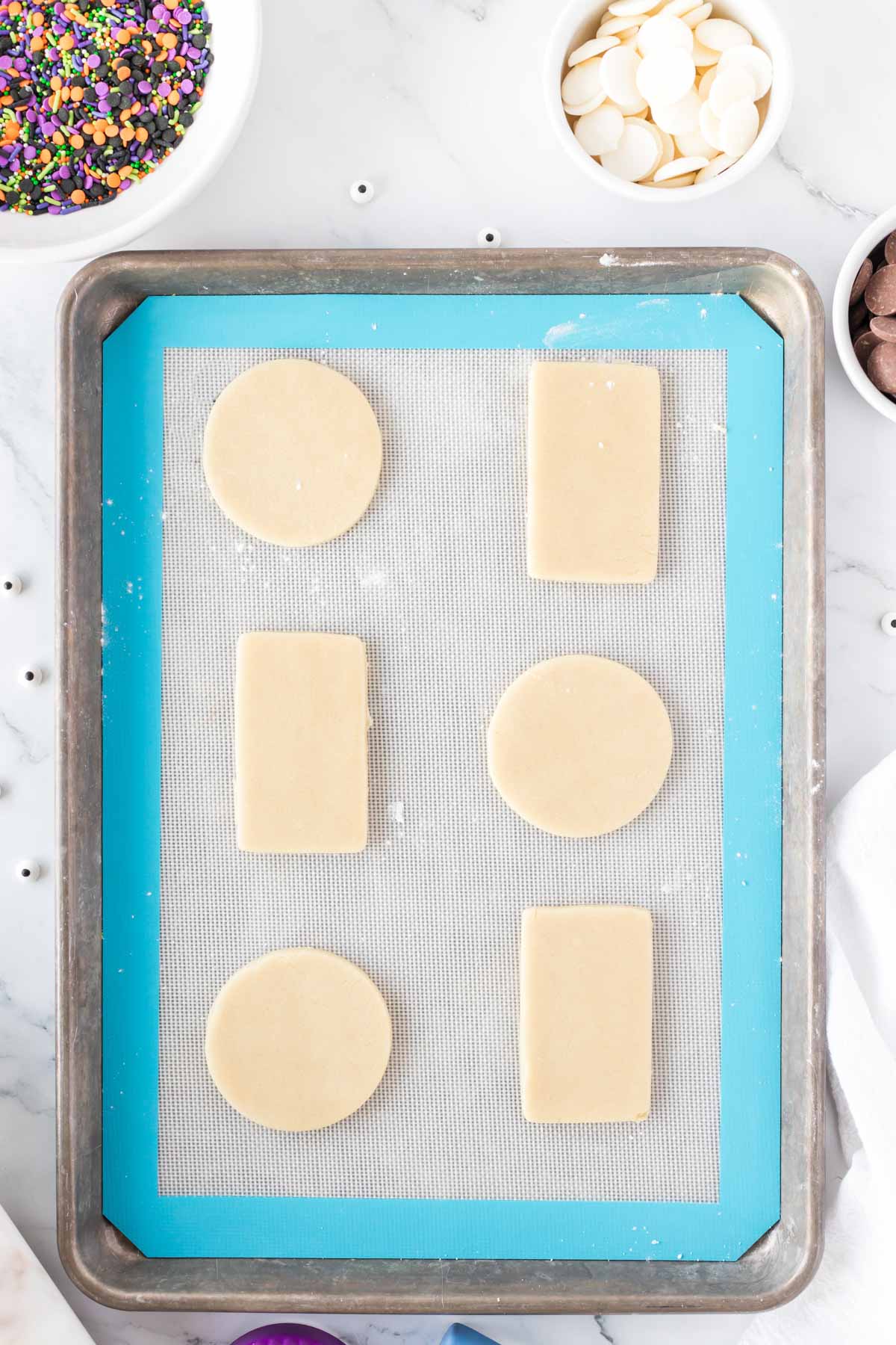 cut out sugar cookies on a baking sheet