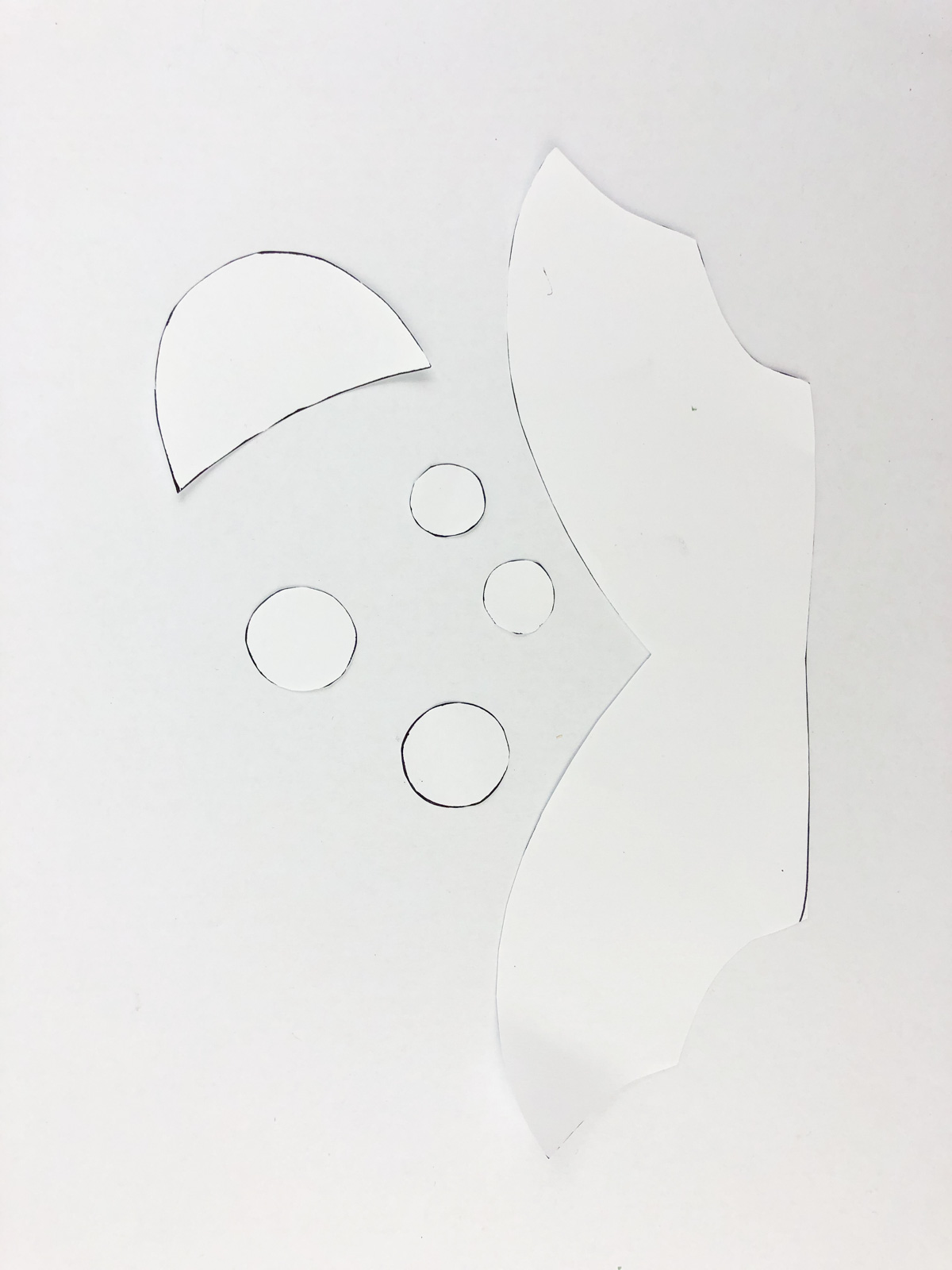 pieces of white paper cut into shapes
