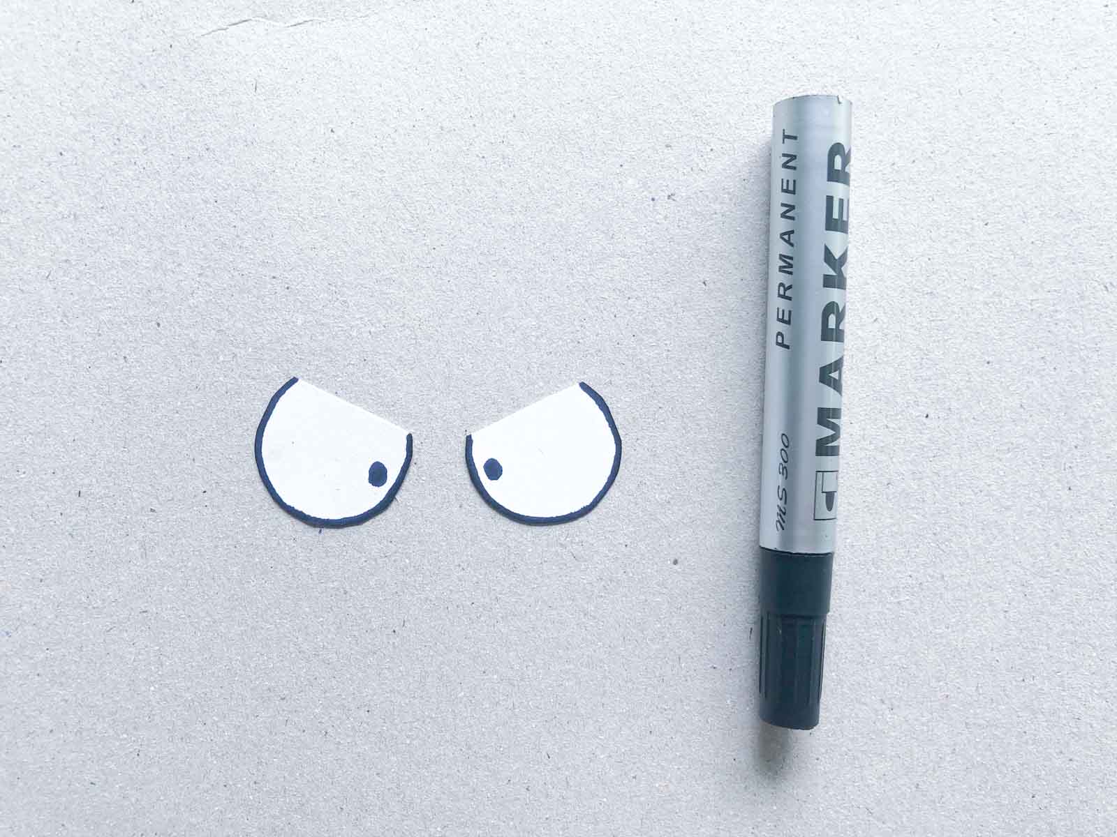 black marker and hand drawn paper eyes