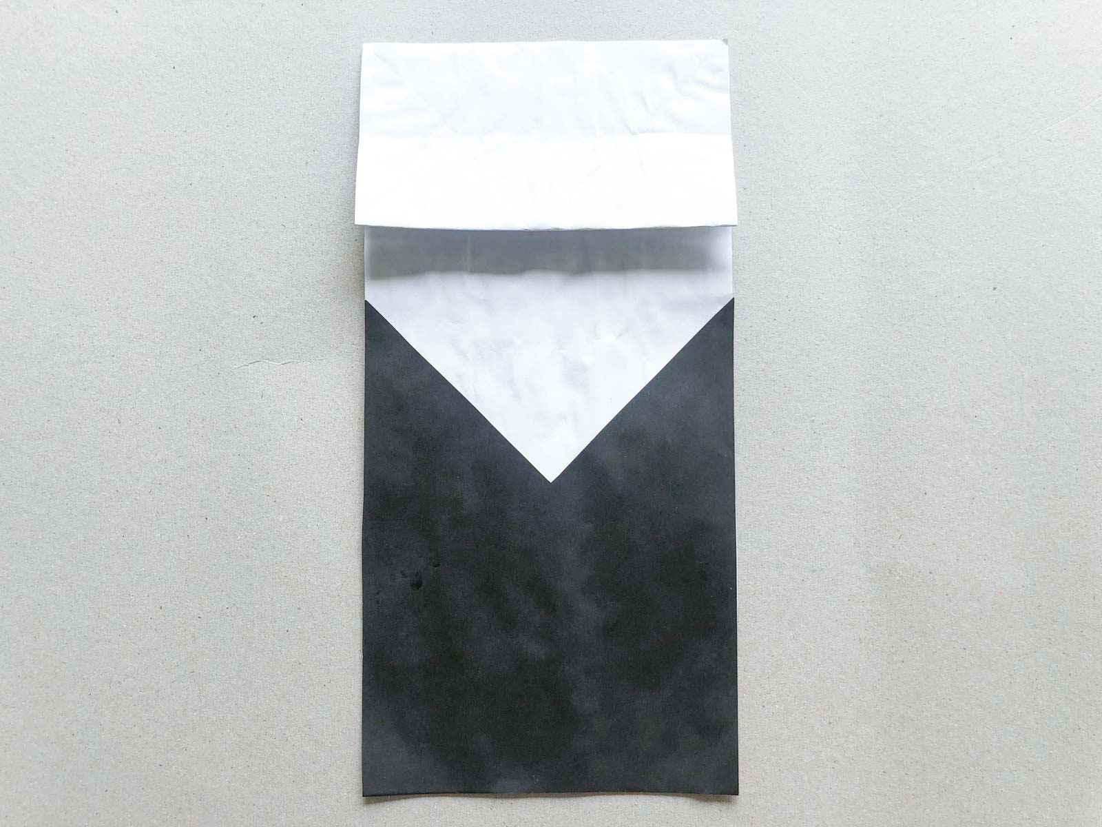 black and white paper glued to a paper bag