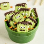 Halloween pretzels that look like Frankenstein in a green bowl