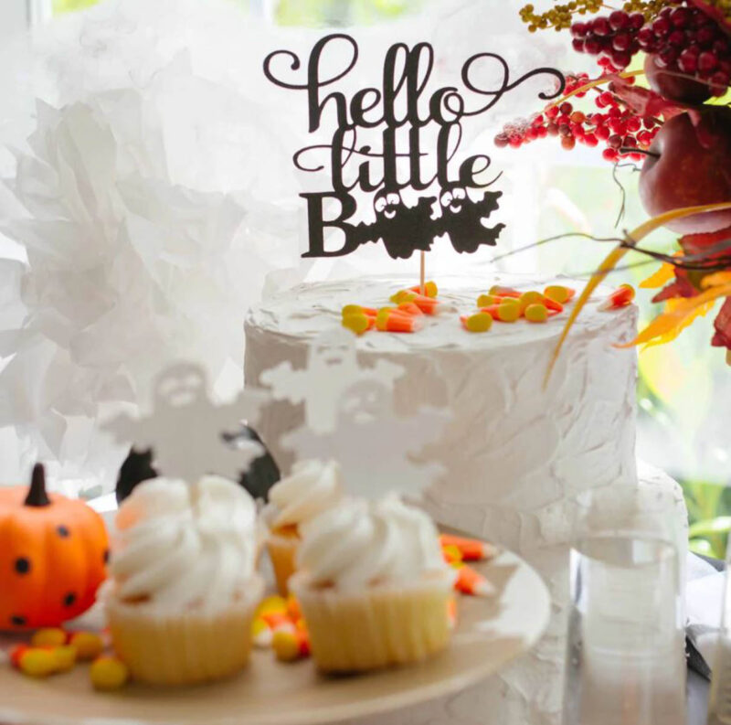 white cake with hello little boo cake topper