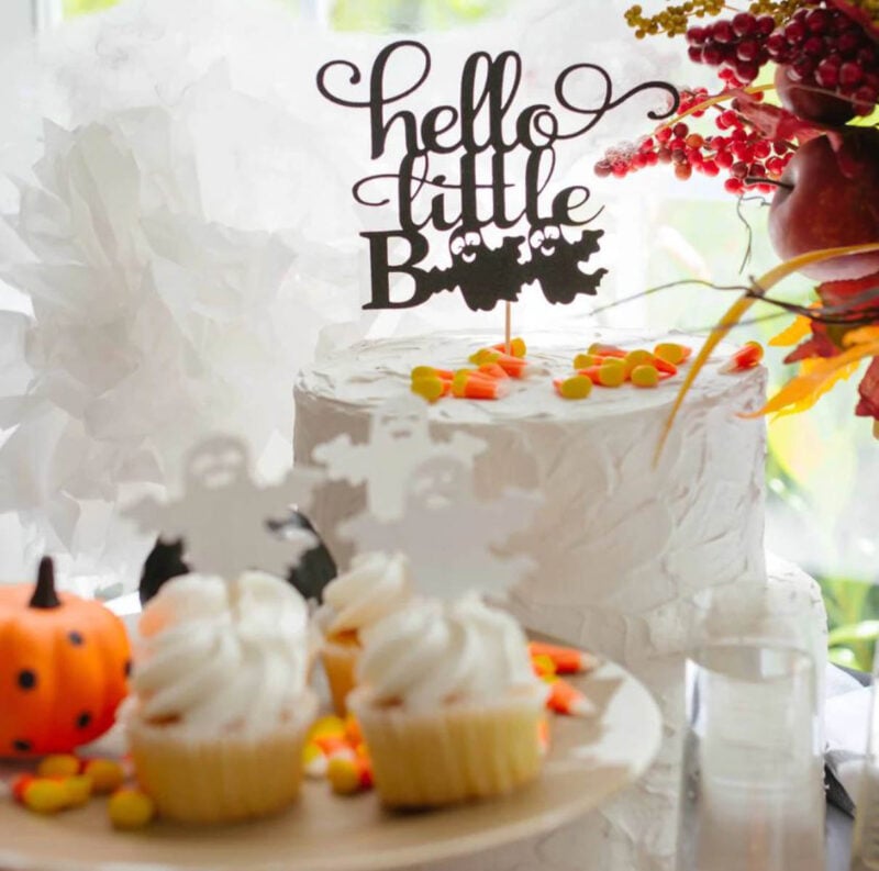 white cake with hello little boo cake topper