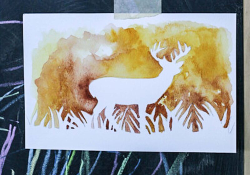 silhouette of deer with fall background