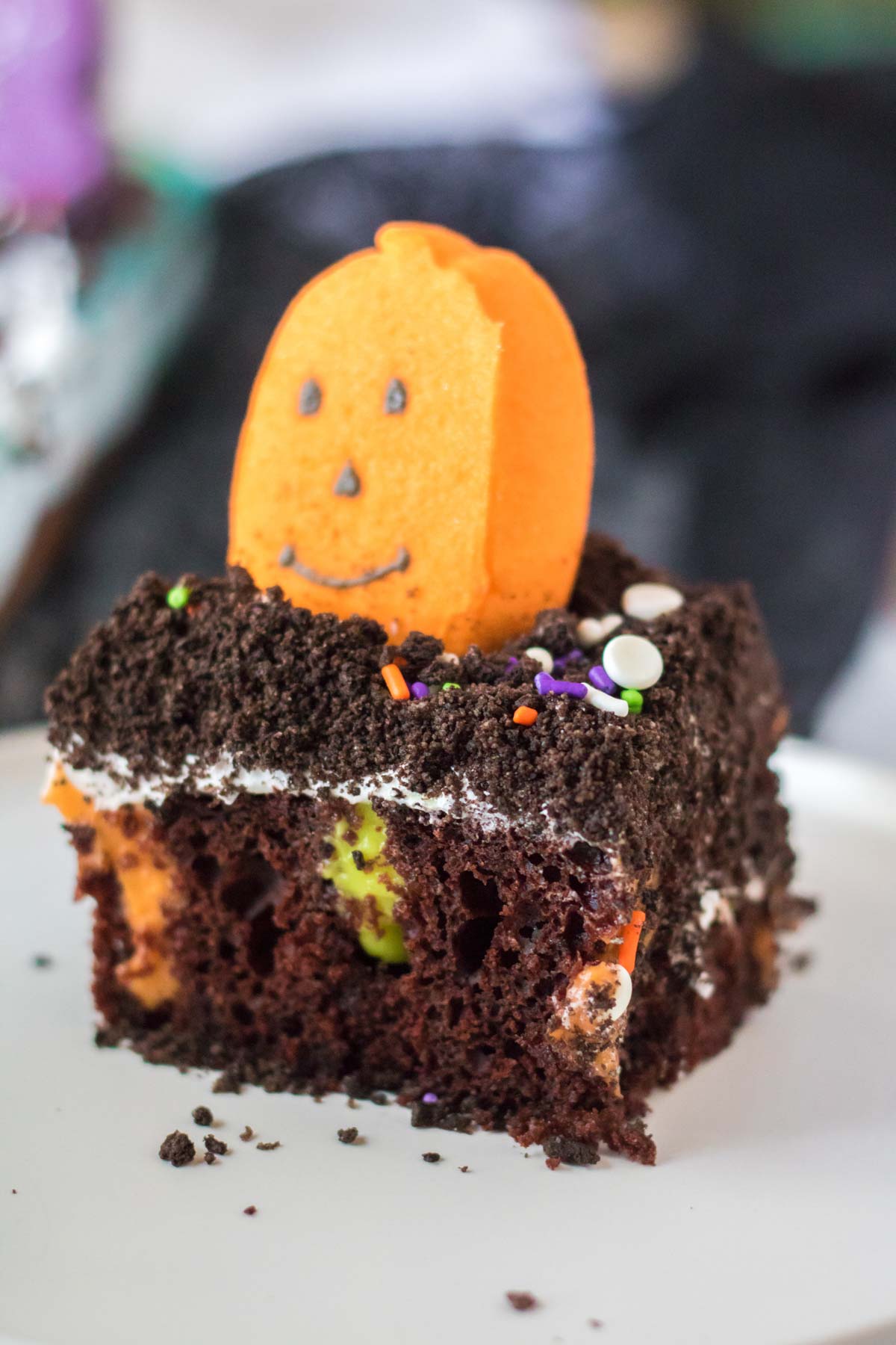 slice of Halloween dirt cake with a pumpkin on top