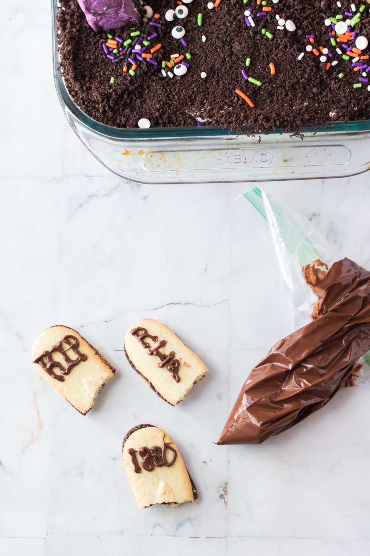 melted chocolate in a bag with Tombstone cookies