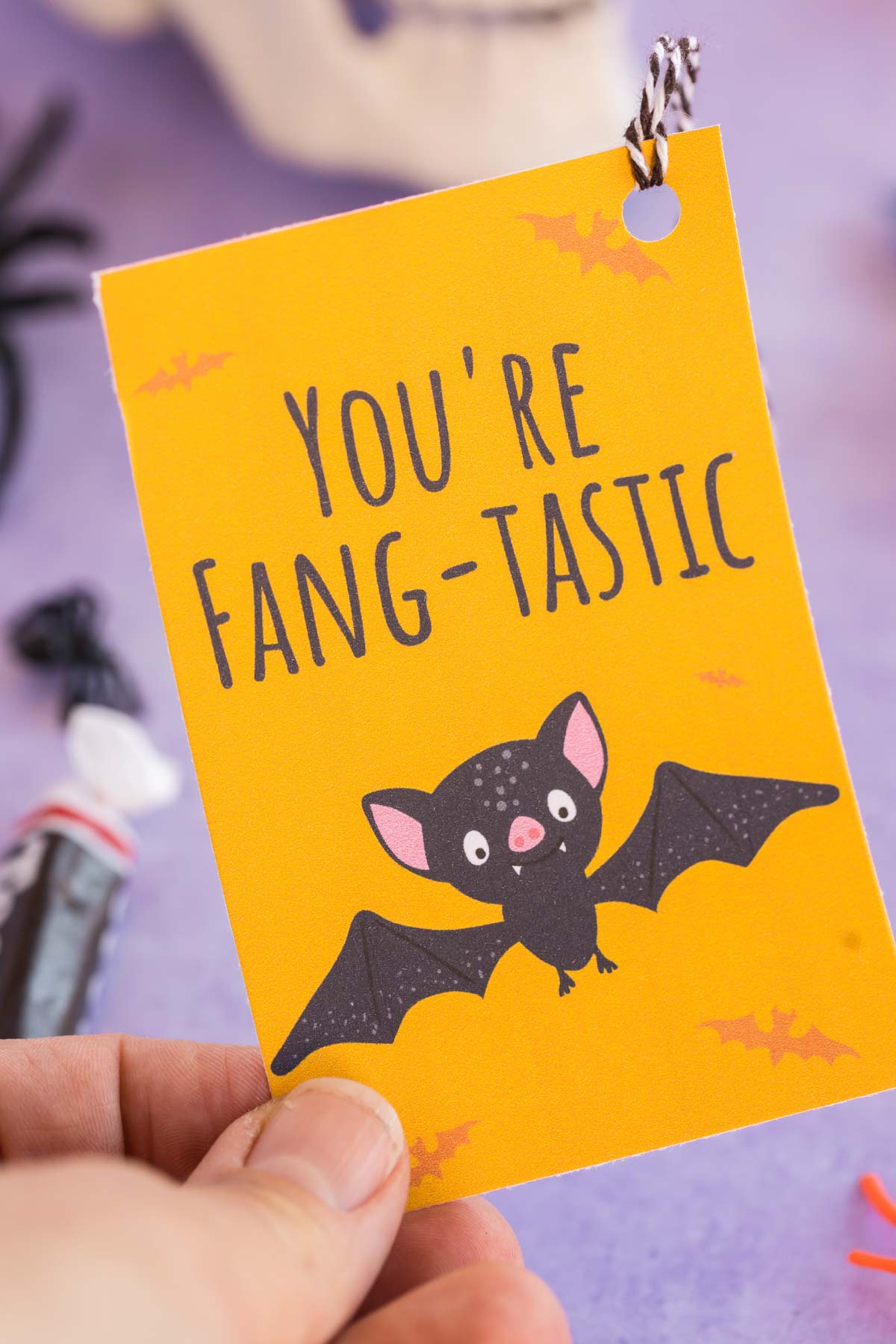 hand holding a bat Halloween gift tag