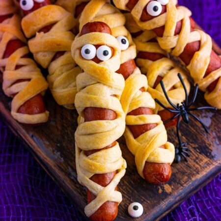 Mummy dogs for Halloween on a purple background