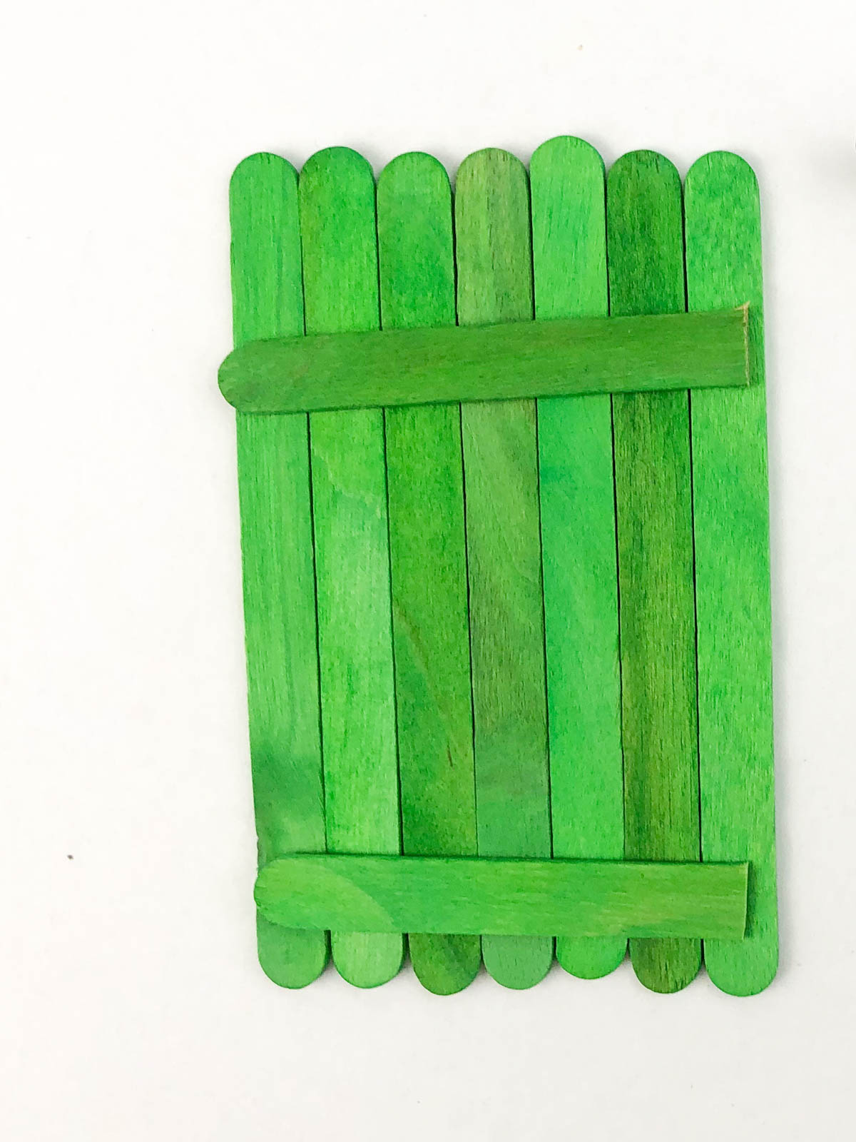 green craft sticks glued together