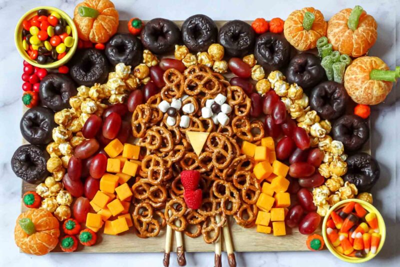 snacks cheese and fruits arranged on tray to look like turkey