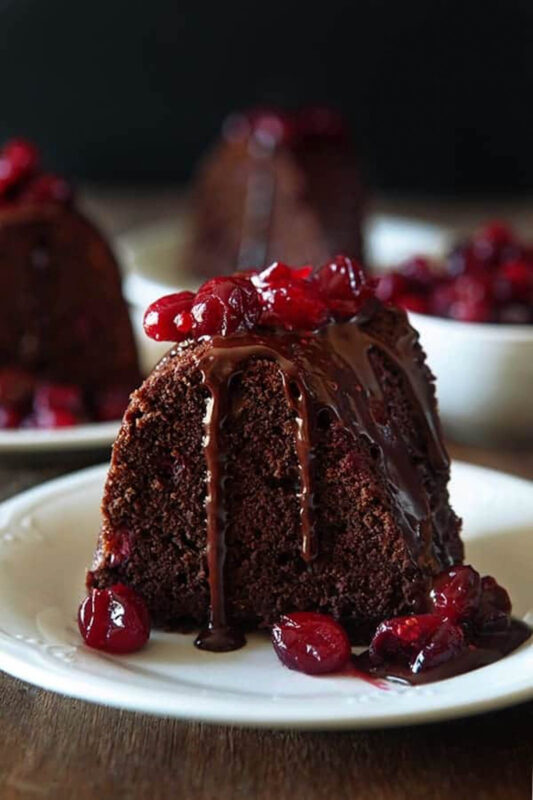 slice of chocolate cake topped with raspberry sauce