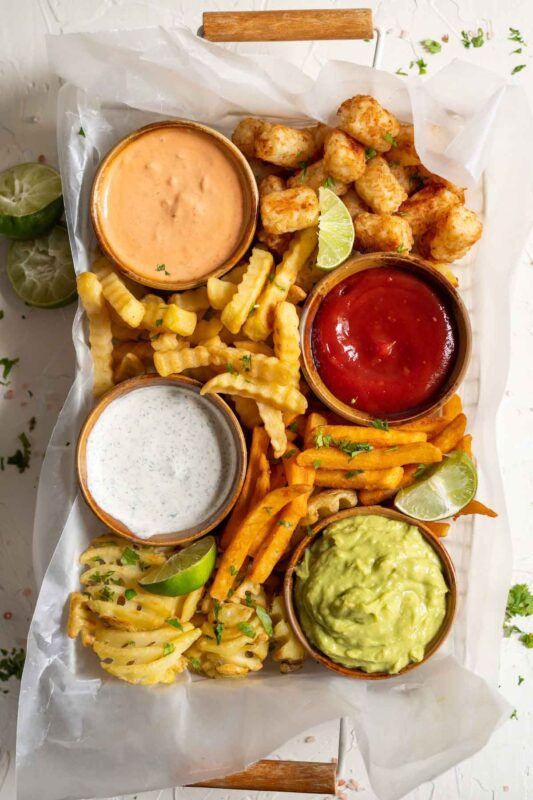 plate with various fries and dipping sauces