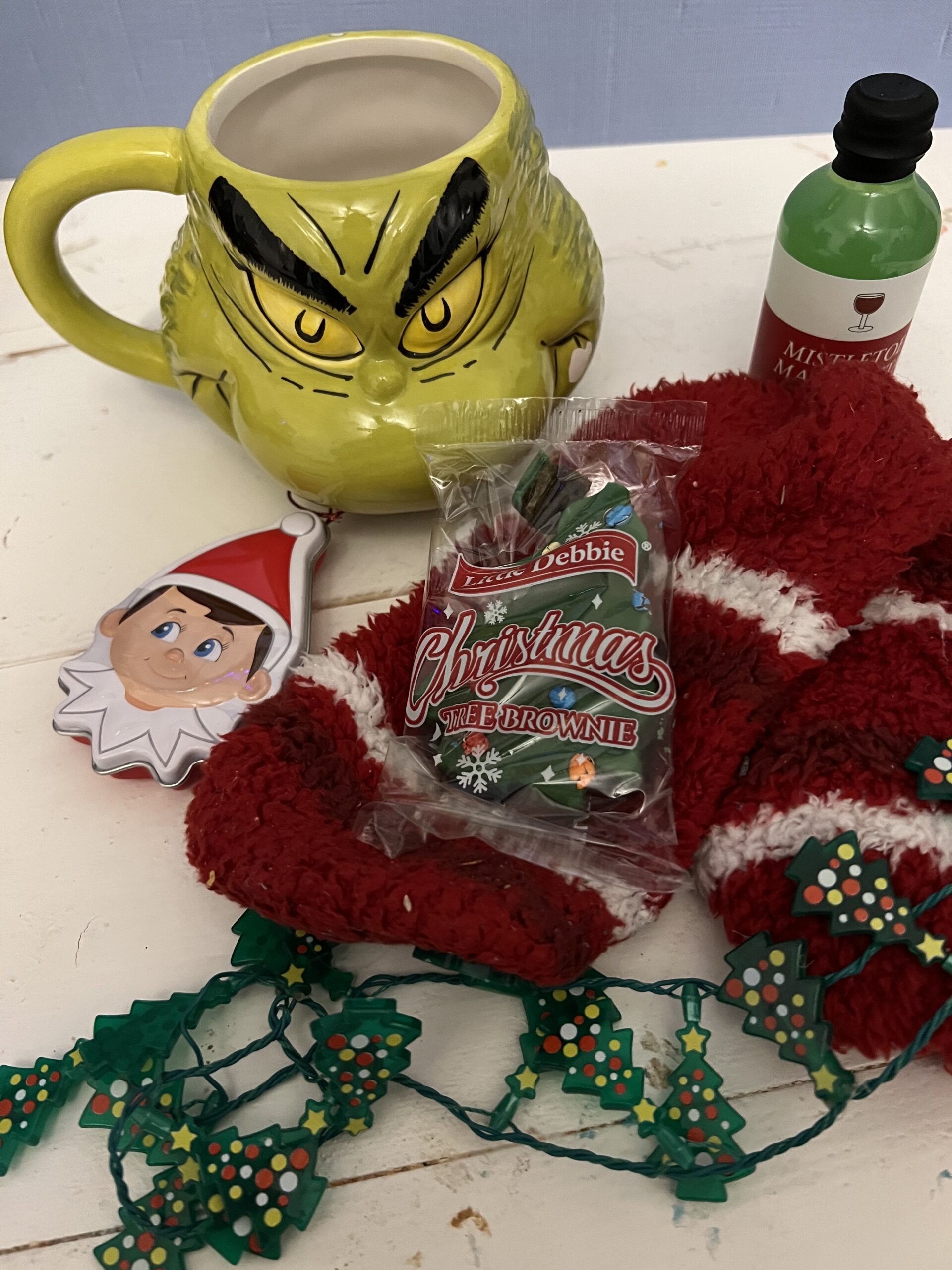 Grinch mug with a bunch of small gifts