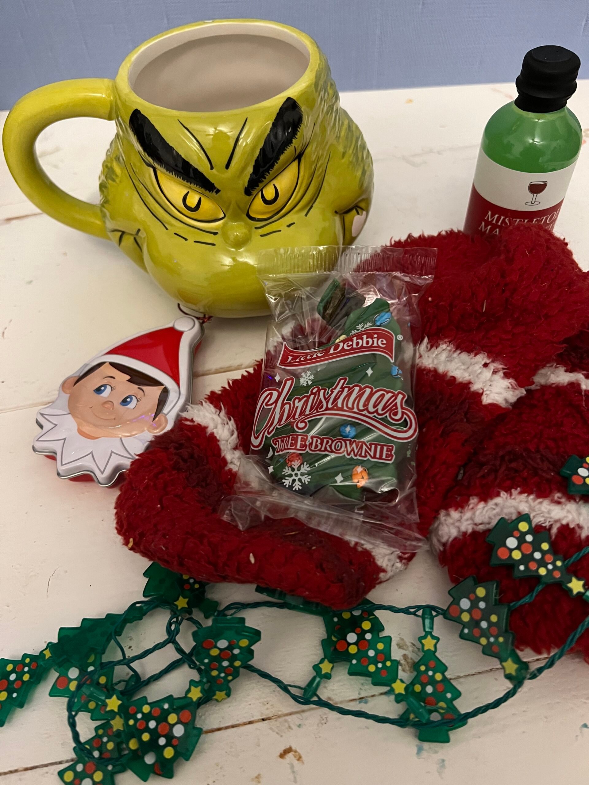 Grinch mug with a bunch of small gifts