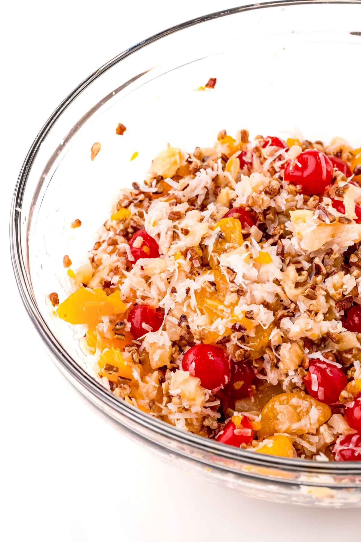 glass bowl with ingredients for ambrosia salad