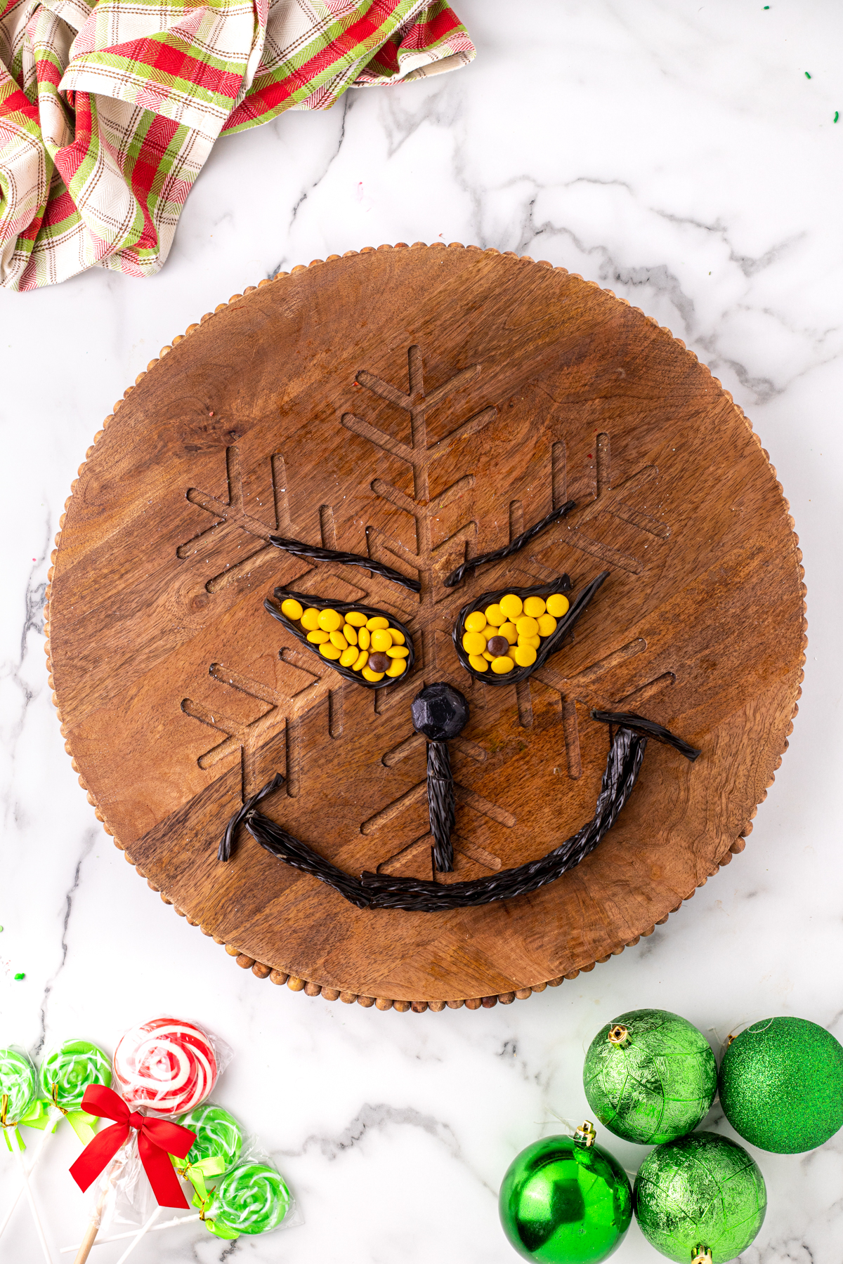 Grinch eyes on a wood charcuterie board