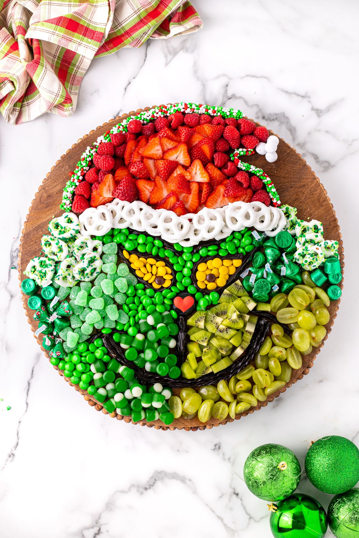 Grinch charcuterie board with a white background