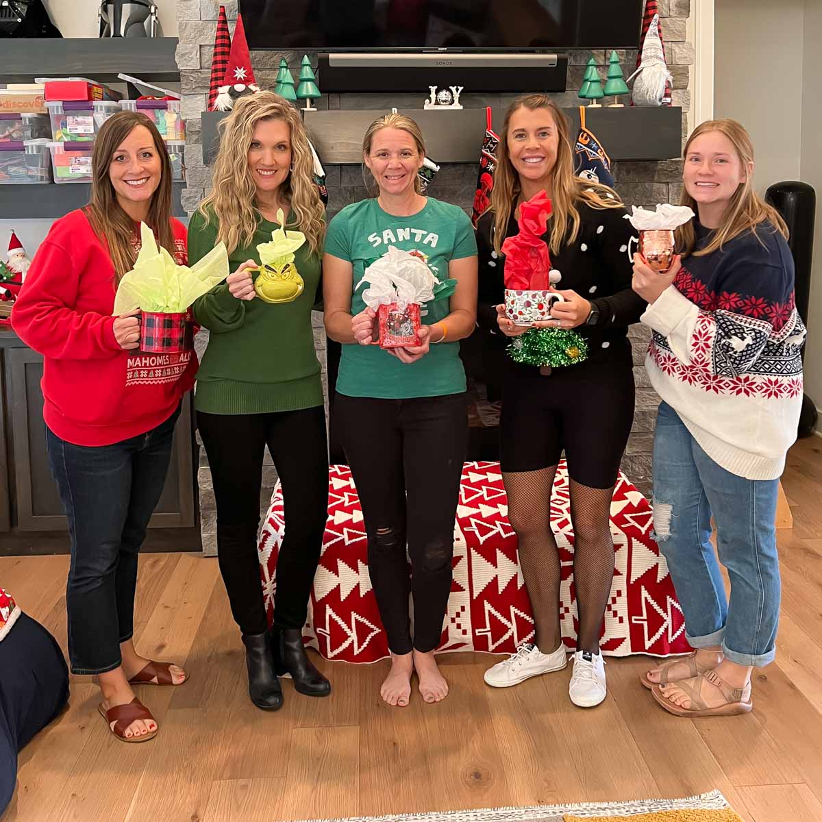 Women holding mugs for a Christmas mug exchange