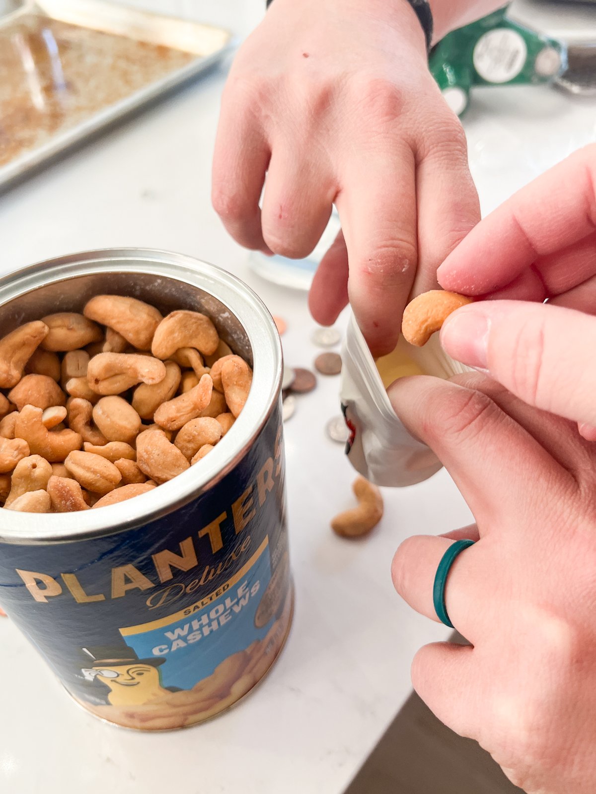 People putting cashews in a balloon