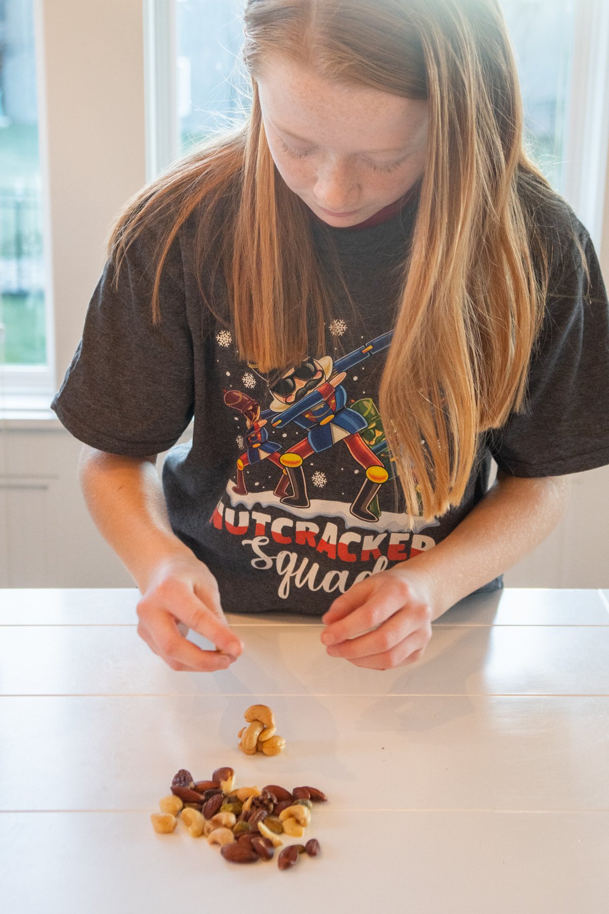 girl sorting mixed nuts