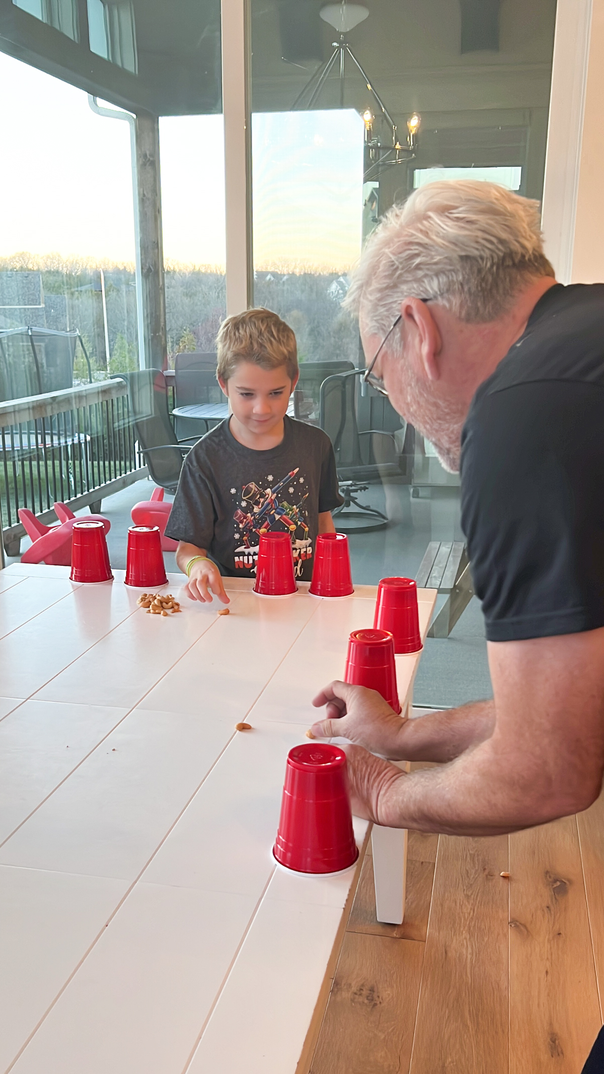 boy and grandpa flicking nuts at each other