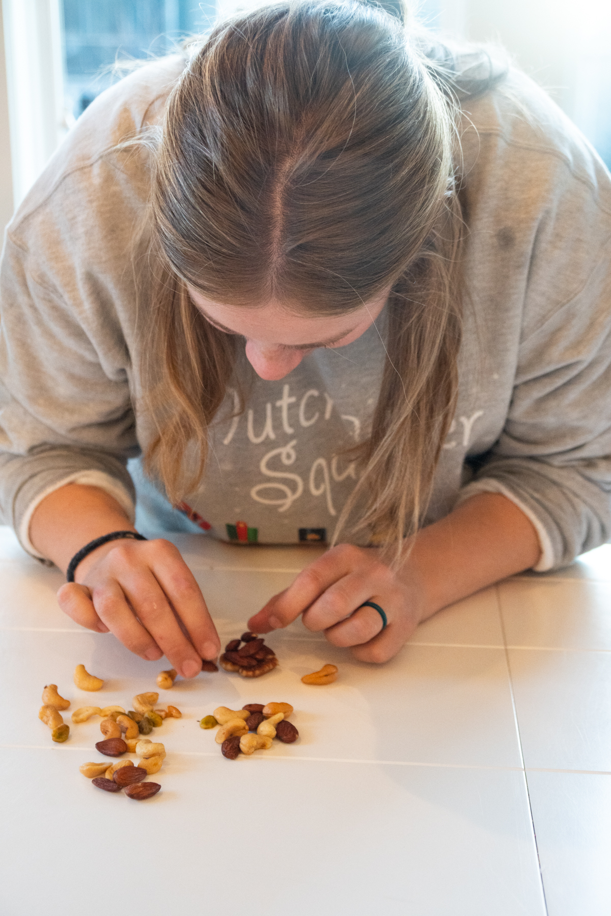 girl sorting mixed nuts