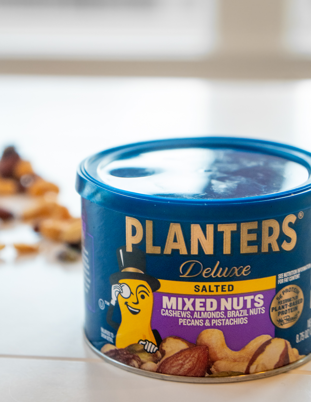 can of salted mixed nuts on a white table