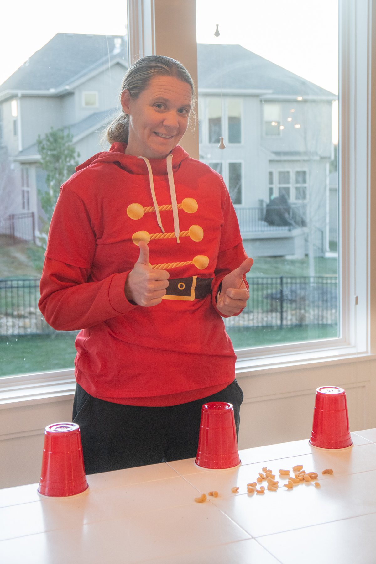 girl in a nutcracker sweatshirt with thumbs up