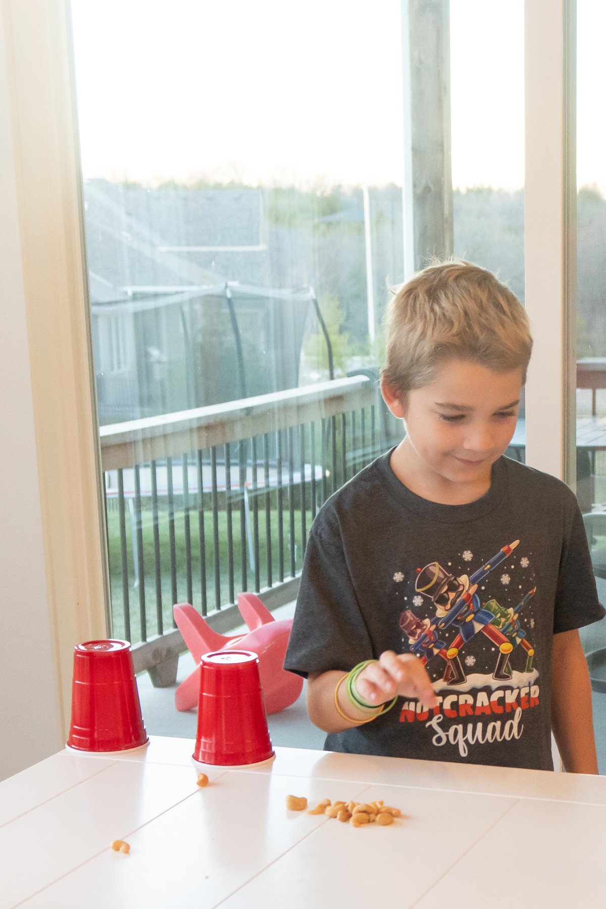 boy flicking a nut on a table