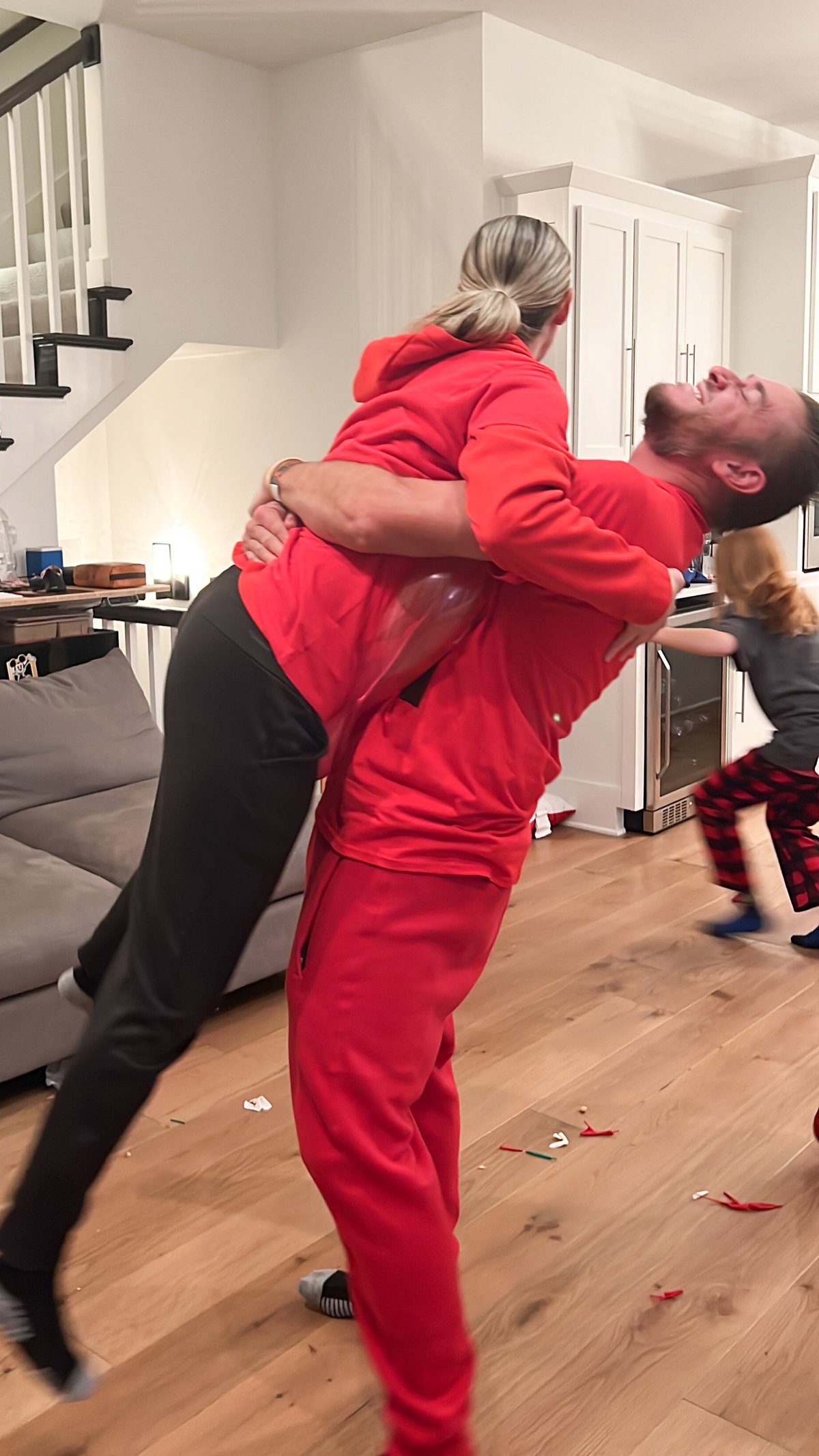 A husband and wife trying to pop a balloon