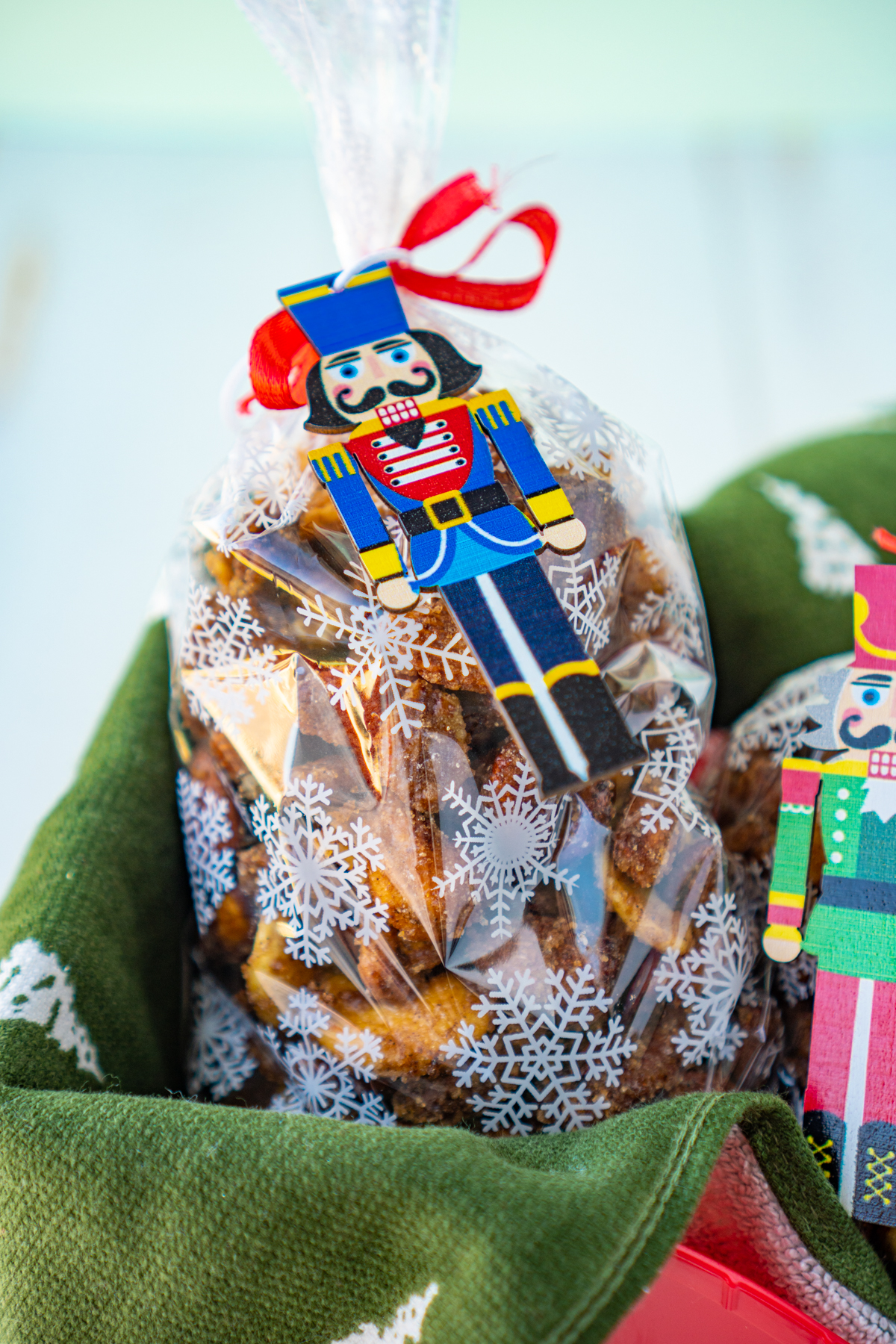Bag of candied nuts with a nutcracker ornament on it