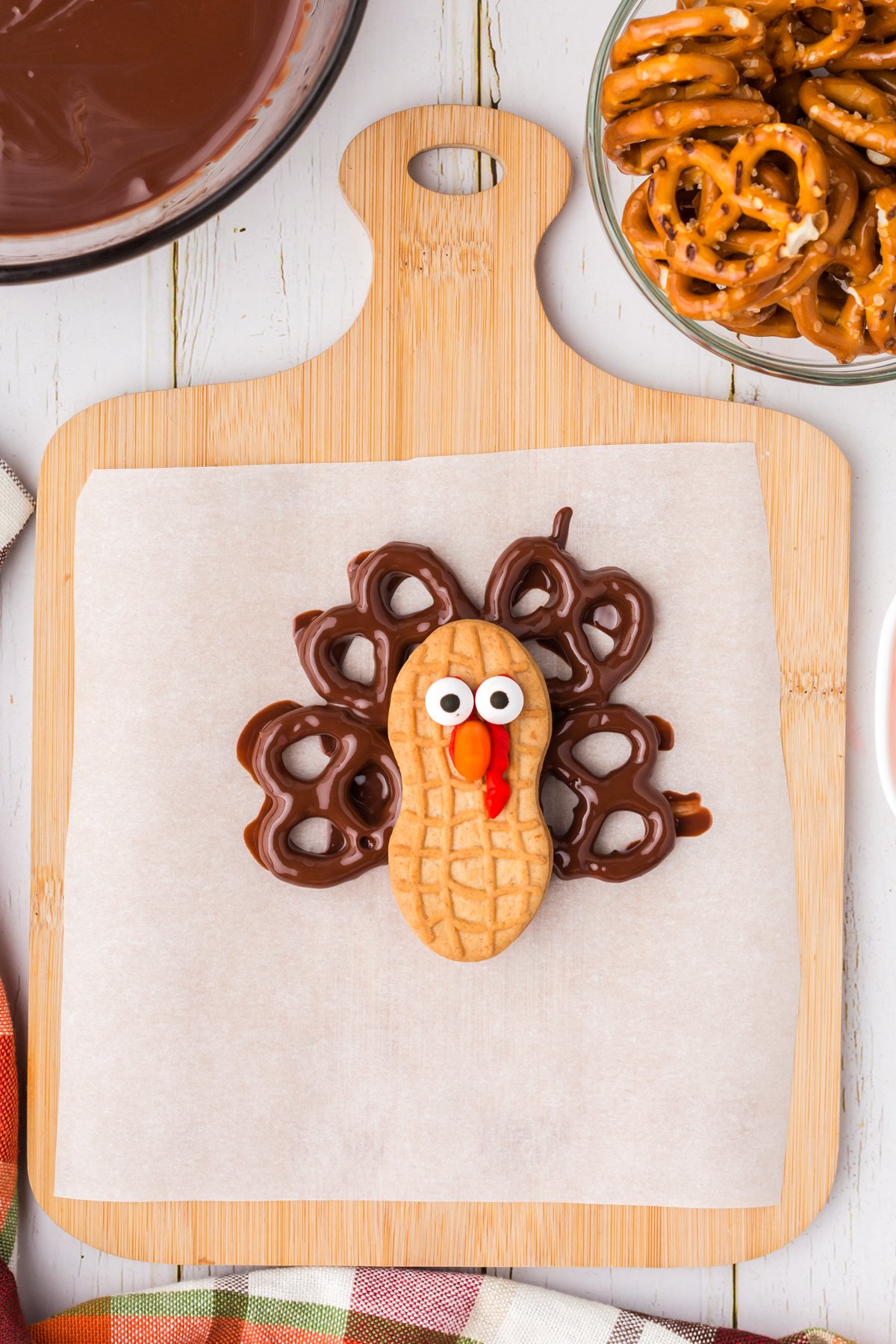 nutter butter turkey cookie on a piece of parchment paper