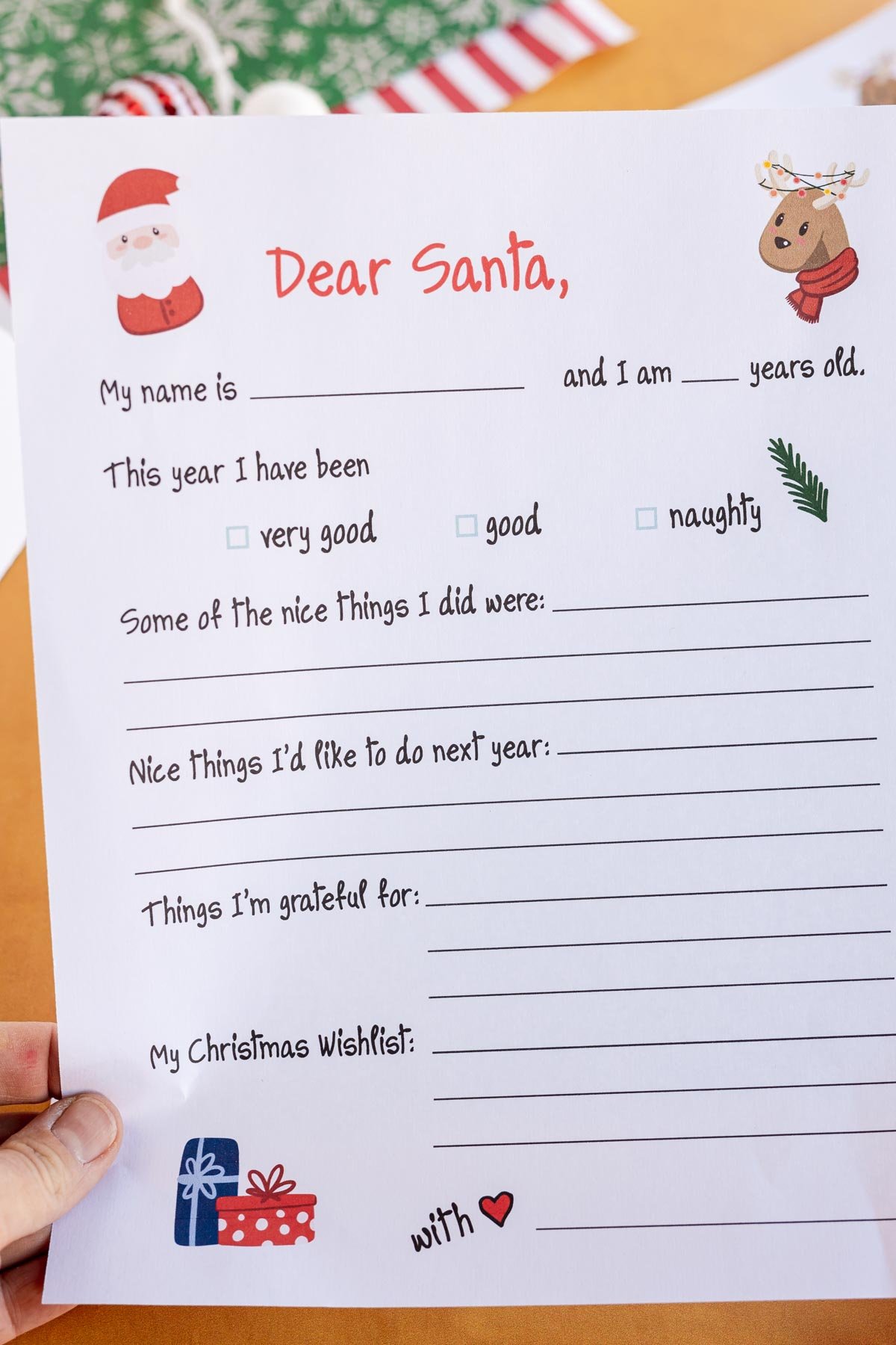 Hand holding a free printable letter to Santa template