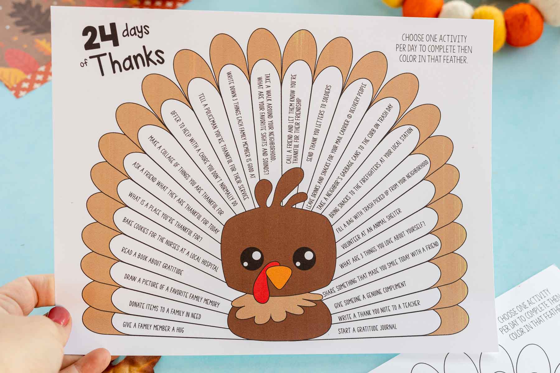 hand holding a printable Thanksgiving turkey