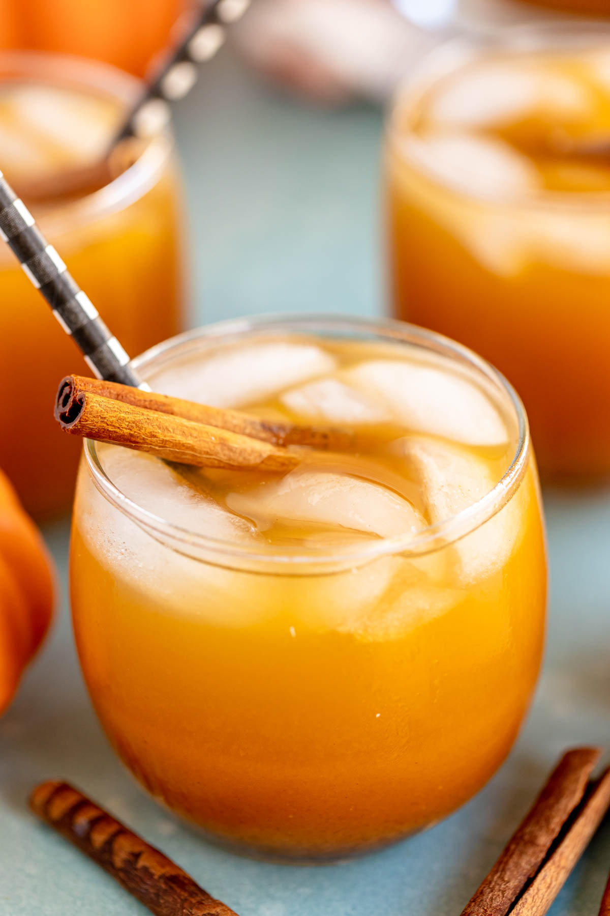 glass of pumpkin juice with a cinnamon stick