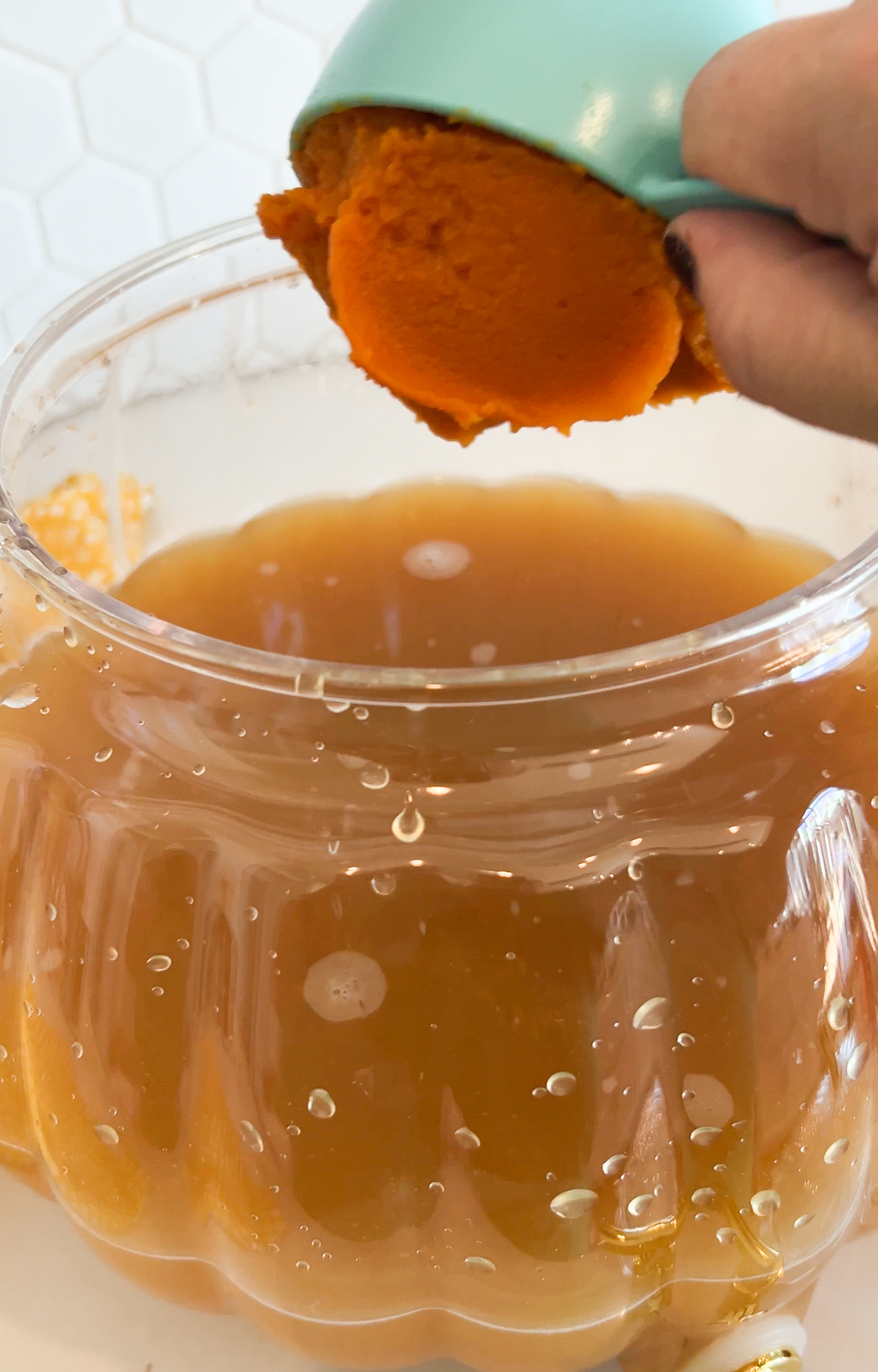 pouring pumpkin into apple cider
