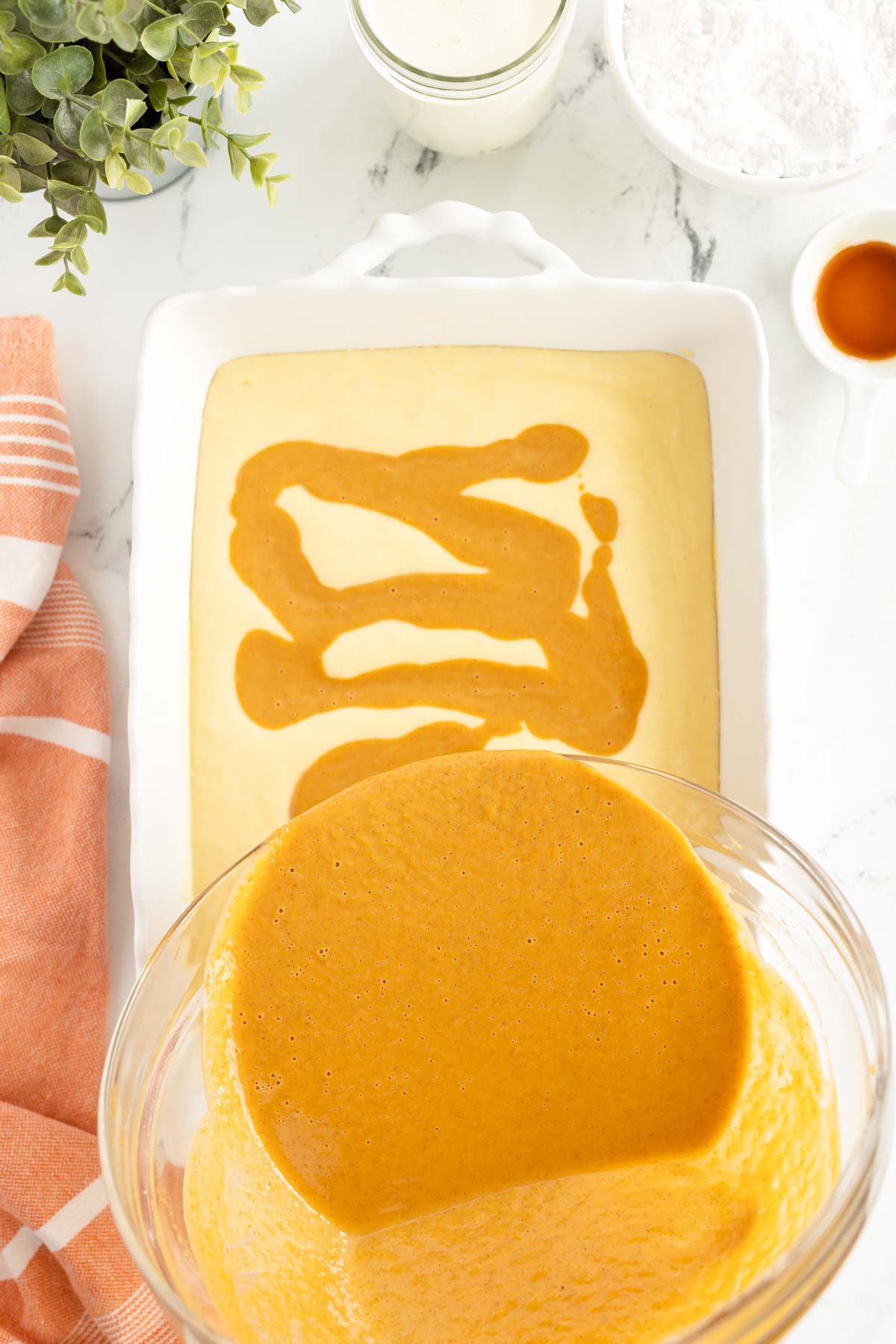 pouring pumpkin mixture over a baking dish