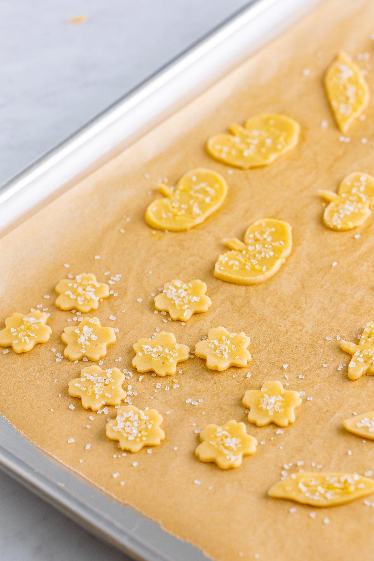 cut out pieces of pie crust on a baking sheet