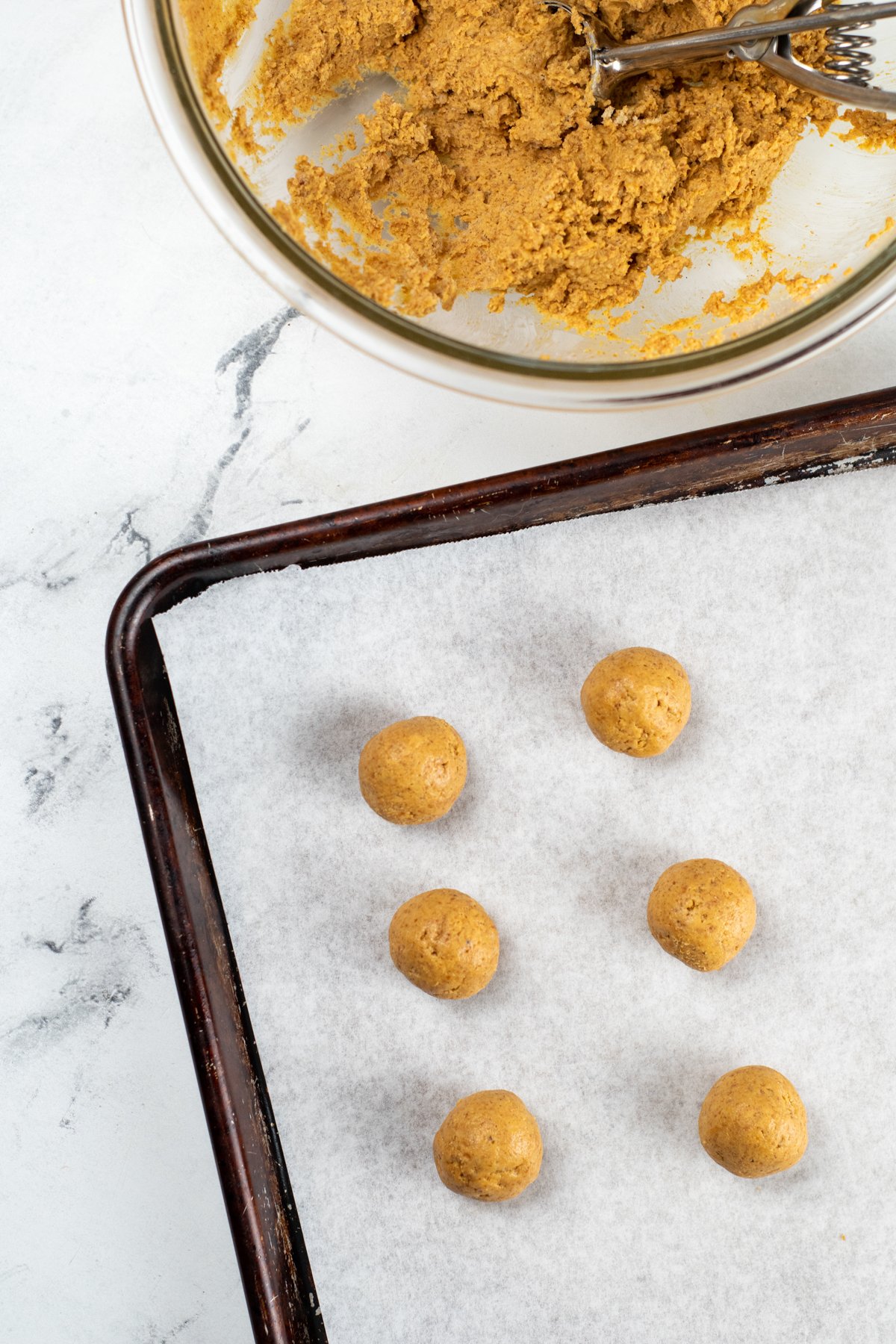 undipped pumpkin balls on a baking sheet