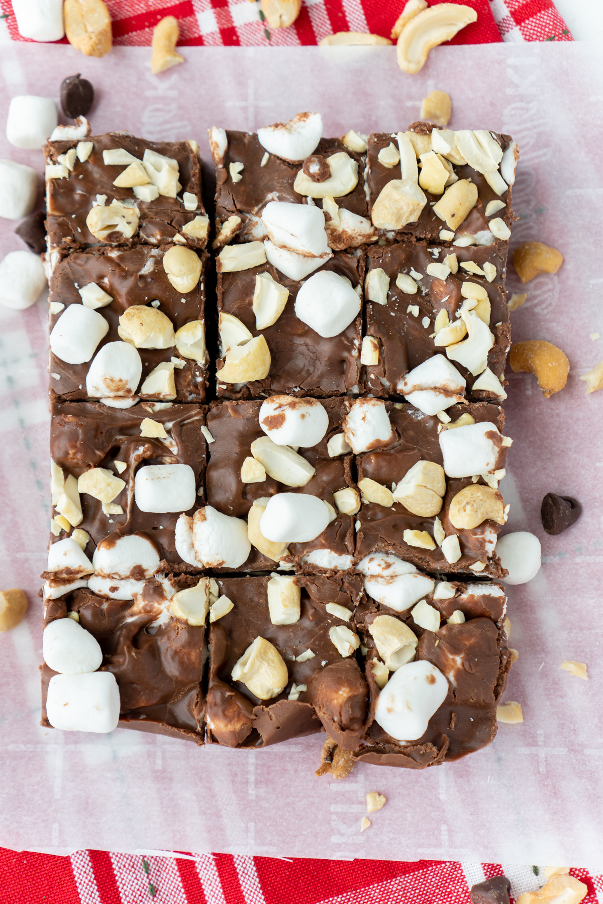squares of rocky road fudge on a piece of parchment paper