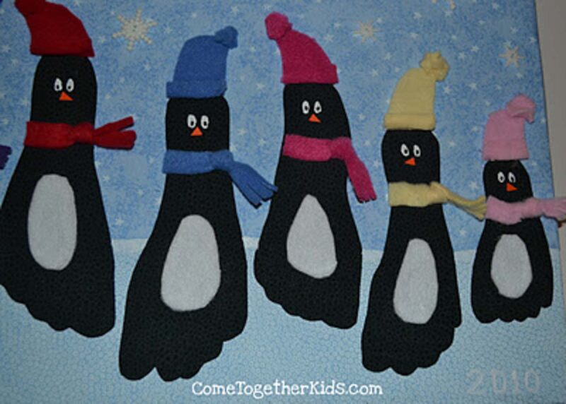 cut out footprint penguins with hats and scarves