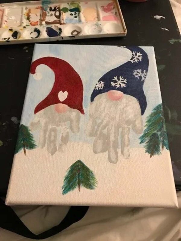 handprint gnomes with painted hats on canvas