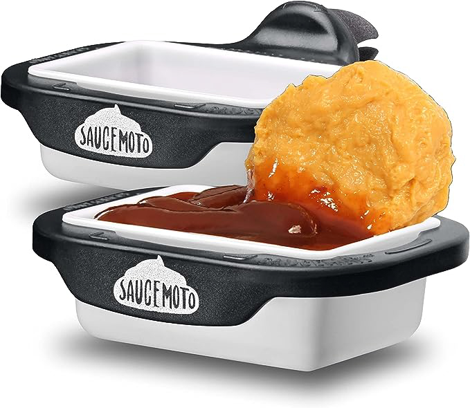 chicken nugget being dipped into sauce cup holder