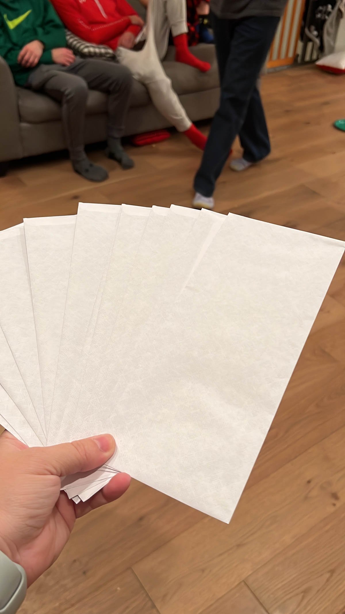 white envelopes spread out in a woman's hand