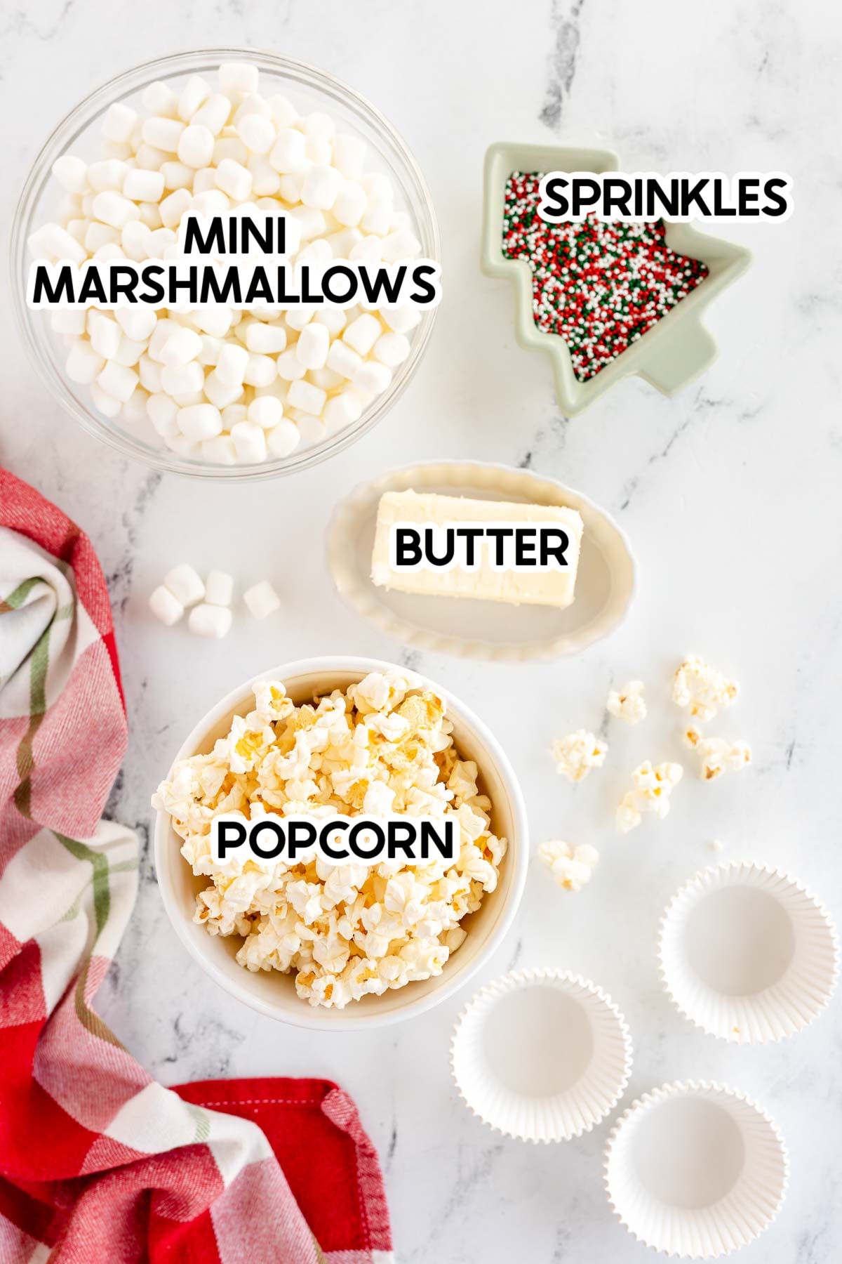 ingredients to make marshmallow popcorn balls with labels