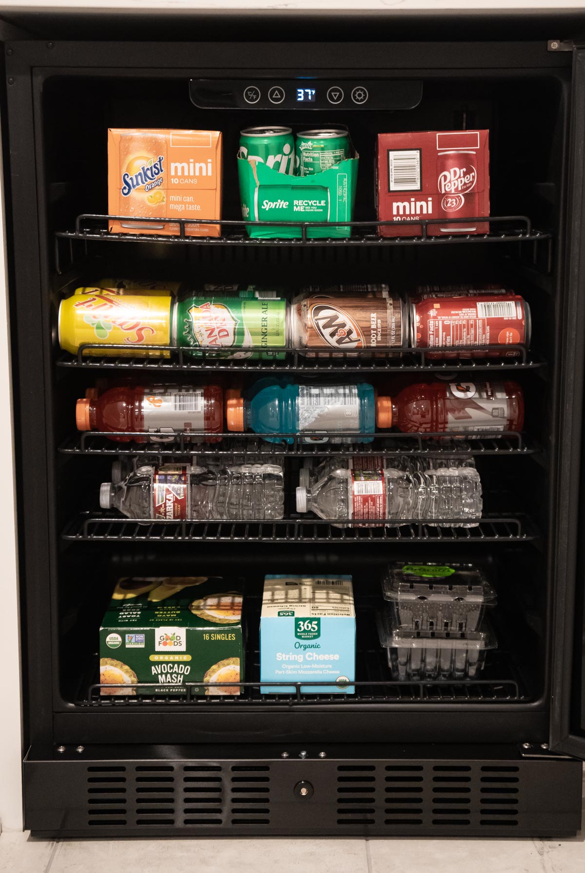 NewAir mini fridge filled with drinks and snacks
